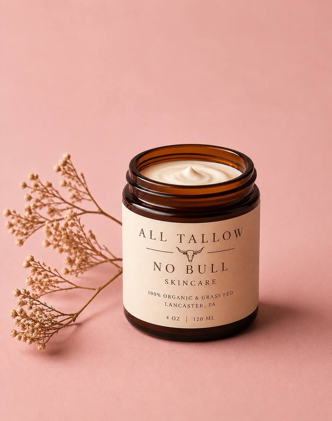 Amber glass jar of All Tallow No Bull face cream on a soft blush background